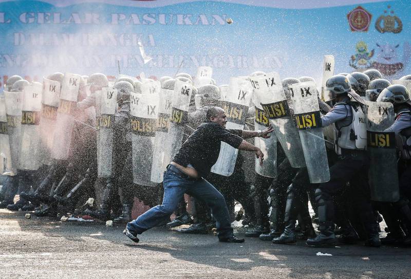 Indonesian police officers block a mock protester during an anti-riot drill as part of security preparations for the upcoming Asian Games 2018 in Jakarta, Indonesia. Mast Irham/EPA