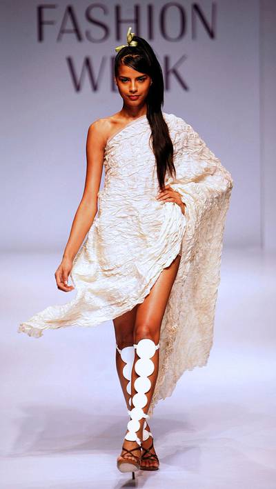 A model displays a creation by designer Wendell Rodricks on the second day of the inaugural Lakme Fashion Week in Mumbai, late 29 March 2006.  The first of two Indian fashion weeks kicked off in Mumbai 28 March after a spat between organisers of rival city shows threatened to overshadow the emergence of a new wave of designers. Thirty designers will show off their ready-two-wear autumn-winter lines at the five-day event taking place just before the larger India Fashion Week in New Delhi -- four days after the Mumbai event ends, 80 designers will display their creations at the seventh and biggest-ever India Fashion Week, run by the Fashion Design Council of India.       AFP PHOTO/Indranil MUKHERJEE (Photo by INDRANIL MUKHERJEE / AFP)