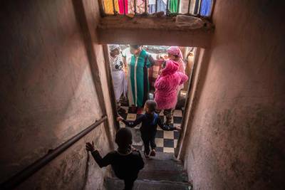Women and children in a housing complex near Rabat, Morocco, March 25. Hundreds of people live in crowded rooms here with no running water and no income left because of the coronavirus lockdown measures. AP