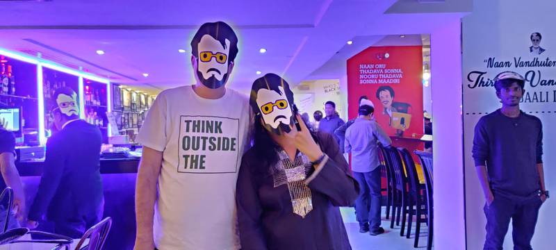 Guests wear Rajinikanth masks at the celebrations 