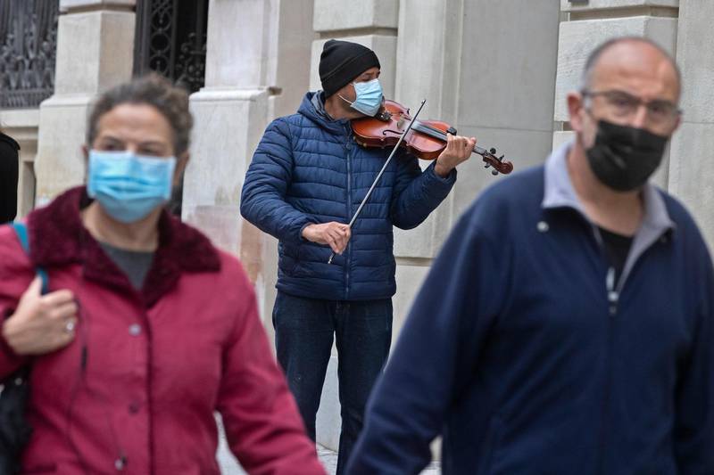 A street musician plays for passers-by in Madrid, Spain, amid the Covid-19 pandemic. AP Photo