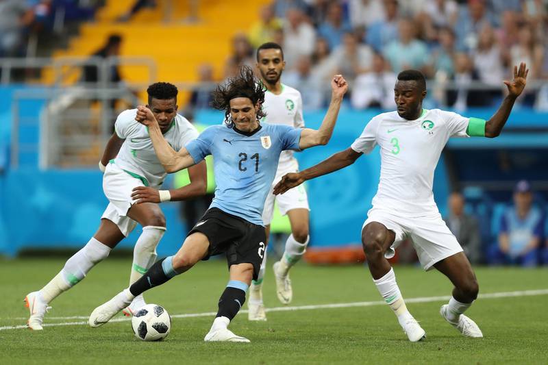 Edinson Cavani of Uruguay is tackled by Osama Hawsawi during the 2018 FIFA World Cup Russia group A match between Uruguay and Saudi Arabia. Clive Rose / Getty Images