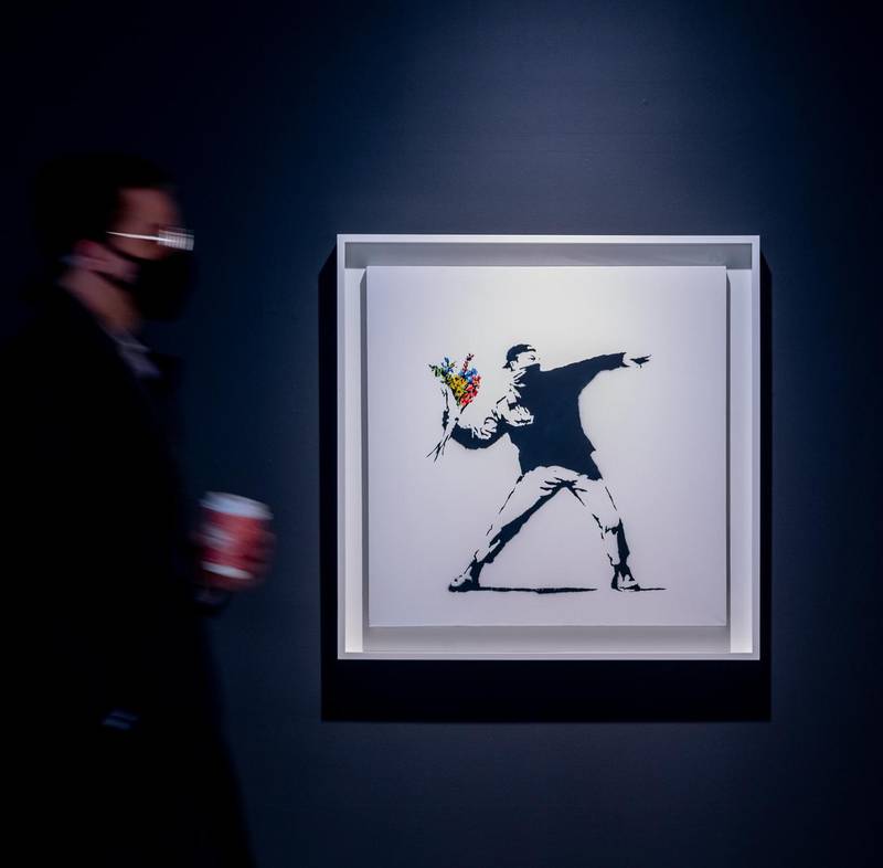 Sotheby's will accept cryptocurrency as payment for Banksy's Love is in the Air, which will be auctioned at a contemporary art event on May 12. Image courtesy of Sotheby's