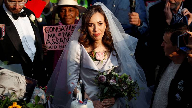 Stella Moris stands next to her wedding cake outside Belmarsh Prison in London, where she married WikiLeaks founder Julian Assange on Wednesday. Reuters