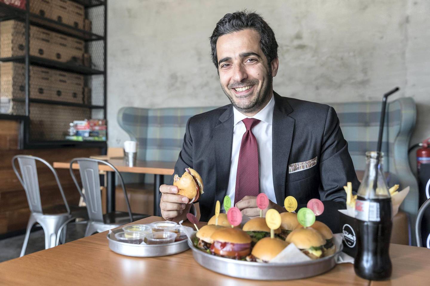 DUBAI, UNITED ARAB EMIRATES. 09 JANUARY 2018. Burger lover Firas Sfair, an architect from Lebanon, at the Smokin’9 mini burger restaurant in JLT Cluster U. (Photo: Antonie Robertson/The National) Journalist: Hala Khalaf. Section: Arts and Culture.