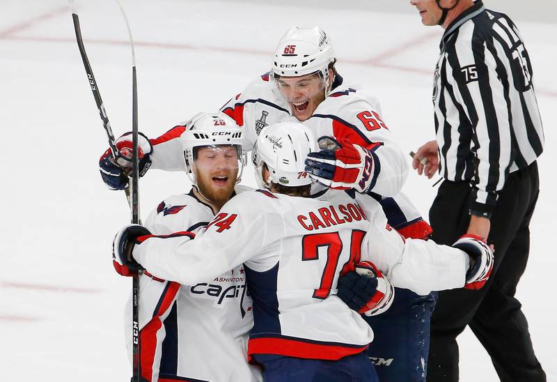 Washington Capitals center Lars Eller, left, celebrates his goal with defenseman John Carlson, center, and left wing Andre Burakovsky, of Austria, during the first period in Game 2 of the NHL hockey Stanley Cup Finals against the Vegas Golden Knights on Wednesday, May 30, 2018, in Las Vegas. (AP Photo/Ross D. Franklin)