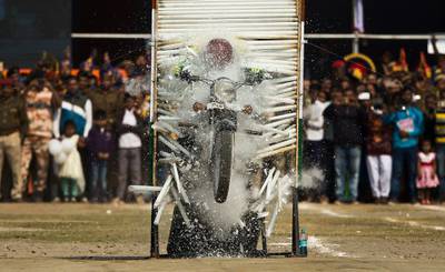 A member of the Assam police force performs a motorcycle stunt in the state capital Gauhati. Anupam Nath / AP Photo