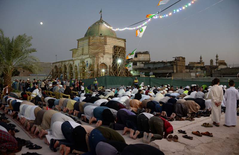 Iraqis kneel to pray during celebrations of the birth of the Prophet Mohammed in the northern city of Mosul.  All photos by AFP
