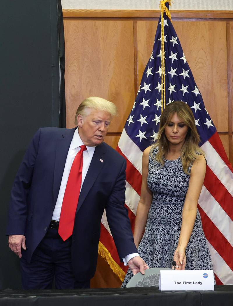 US President Donald Trump helps first lady Melania Trump with her seat while attending a SpaceX mission briefing at the Kennedy Space Centre in Cape Canaveral. Reuters