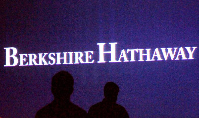 FILE PHOTO: Berkshire Hathaway shareholders walk by a video screen at the company's annual meeting in Omaha May 4, 2013.  REUTERS/Rick Wilking/File Photo