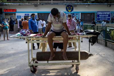 A patient suffering from the coronavirus disease (COVID-19) waits to get admitted outside the casualty ward at Guru Teg Bahadur hospital, amidst the spread of the disease in New Delhi, India, April 23, 2021. REUTERS/Danish Siddiqui