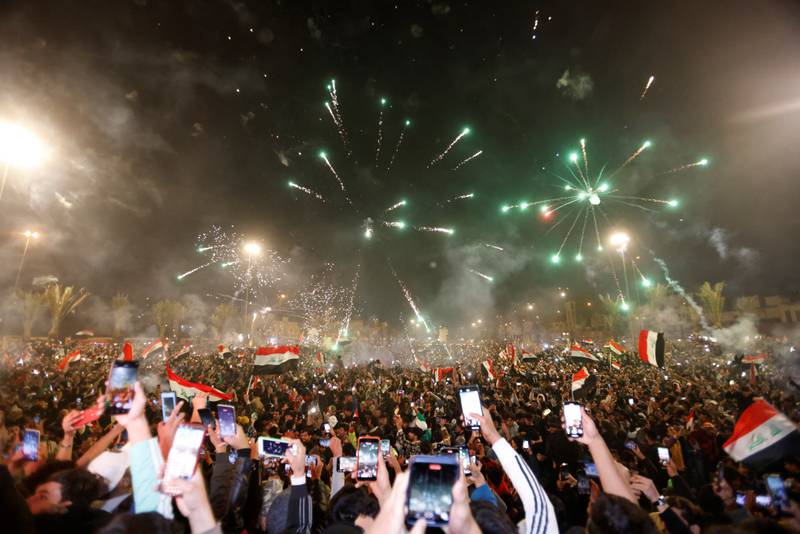 Fans celebrate Iraq's win against Qatar in the semi-finals of the Arabian Gulf Cup at Tahrir Square in Baghdad. Reuters