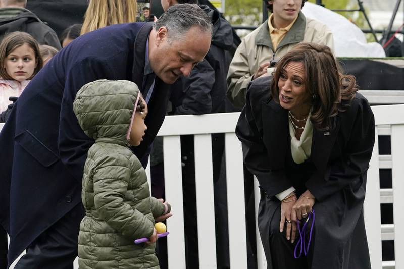 Vice President Kamala Harris and Second Gentleman Doug Emhoff chat to a child. AP