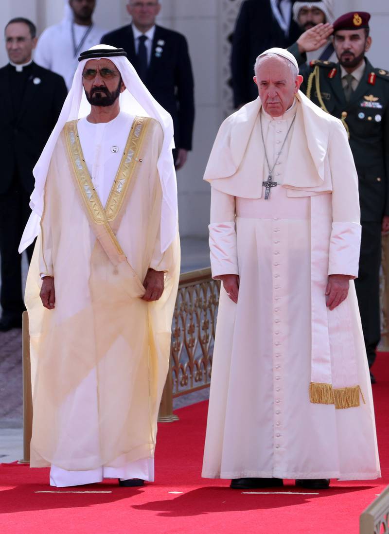 Pope Francis walks with Sheikh Mohammed bin Rashid. Reuters