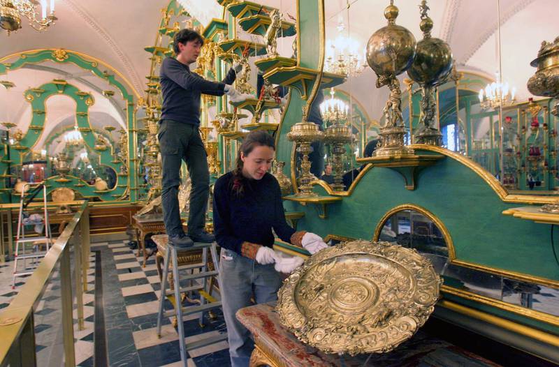Restorers clean parts of the silver-golden room in the Green Vault. EPA