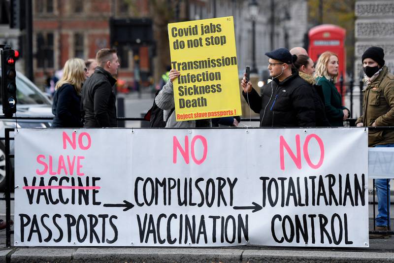 An anti-vaccination sign is displayed near the Houses of Parliament in London. Reuters