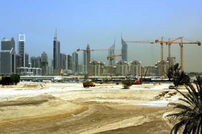 The construction site of the "Burj Dubai" that will become the world's tallest tower, is seen 29 April 2005 in Dubai. At its construction peak, more than 20,000 workers will be labouring to create 45 million square feet of space for 30,000 homes, "making the Burj Dubai site the biggest single construction site in the world".  AFP PHOTO/Rabih MOGHRABI (Photo by Rabih MOGHRABI / AFP)