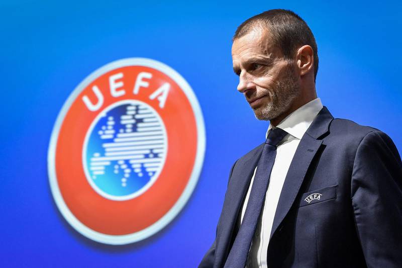 (FILES) In this file photo taken on December 4, 2019 UEFA President Aleksander Ceferin walks past a sign with the UEFA logo after attending a press conference following a meeting of the executive committee at the UEFA headquarters, in Nyon, Switzerland. UEFA president Aleksander Ceferin on June 23, 2021 said the footballing body could not give in to "populist" requests from politicians, as he defended the decision not to allow Munich's Allianz Arena to be lit up in rainbow colours. "UEFA cannot be used as a tool by politicians," Ceferin told Germany's Die Welt newspaper after Munich's mayor had made the rainbow request in protest at Hungary's anti-LGBTQ law. / AFP / Fabrice COFFRINI
