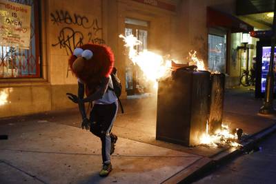 A protester in an Elmo mask dances during a Philadelphia protest. AP Photo