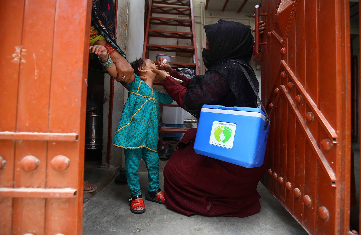 A health worker gives a polio vaccine to a child in Quetta, Pakistan, in May.  Environmental Protection Agency