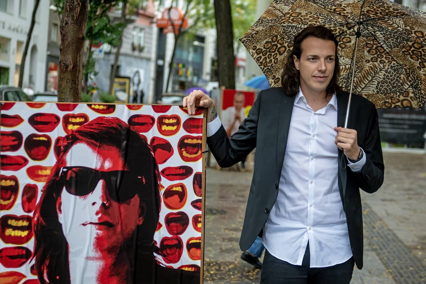 Presidential candidate and punk rock singer Dominik Wlazny poses with a campaign poster in Vienna. EPA 