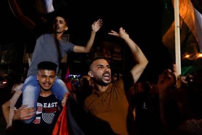 Palestinians celebrate on a street in Gaza city after a ceasefire was announced. Reuters
