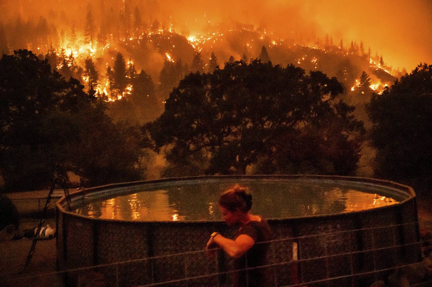 A Klamath National Forest resident feels the effects of Mckinney's flames on Saturday night. AP