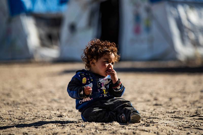 A picture shows a child sitting at the Kurdish-run al-Hol camp, which holds relatives of suspected Islamic State (IS) group fighters in the northeastern Hasakeh governorate. Al-Hol is the larger of two Kurdish-run displacement camps for relatives of IS jihadists in Syria's northeast.  It holds mostly Syrians and Iraqis but also thousands from Europe and Asia suspected of family ties with IS fighters.   AFP