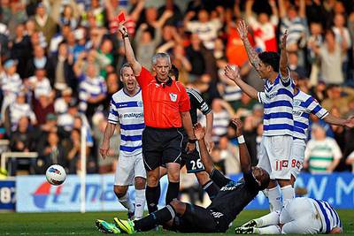 Didier Drogba, centre, is sent off by Chris Foy, the referee, after a two-footed lunge on Adel Taarabt. Jose Bosingwa was also sent off as QPR won 1-0.

Kerim Okten / EPA