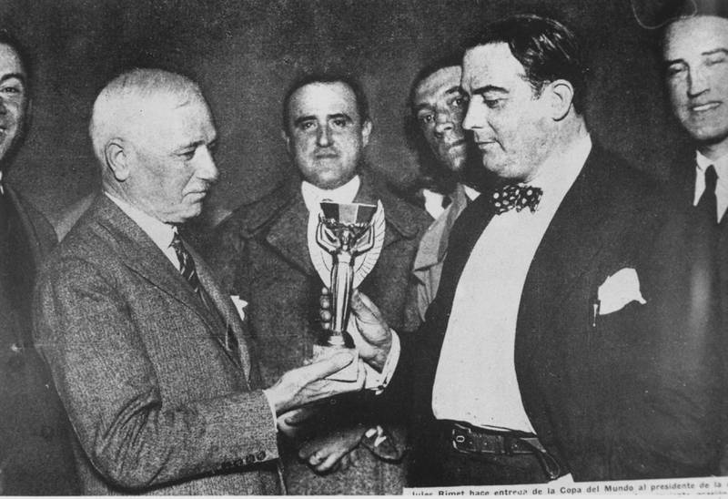 Jules Rimet, president of Fifa, presents the first World Cup trophy to Dr Paul Jude, the president of the Uruguayan Football Association, after Uruguay beat Argentina 4-2 in the first ever World Cup final in Montevideo, Uruguay, on July 30, 1930. Getty