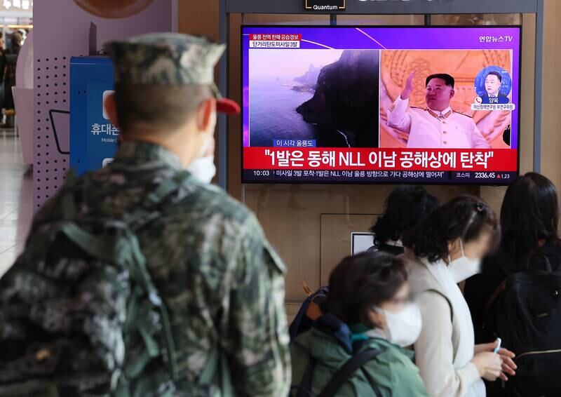 A soldier at Seoul Railway Station watches a TV news report about North Korea's missile tests. EPA