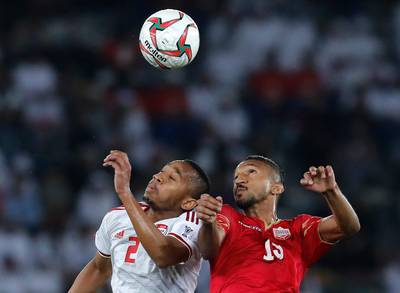 United Arab Emirates' midfielder Ali Salmeen, left, and Bahrain's forward Mohamed Al Rohaini jump for the ball. AP Photo