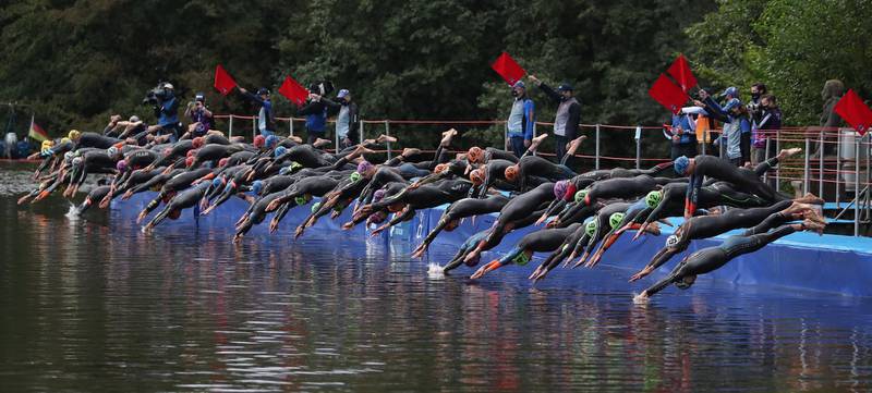 Athletes begin the swimming section of the men's elite race at the Hamburg Wasser World Triathlon event in Hamburg, northern Germany, on Saturday, September 5.  EPA