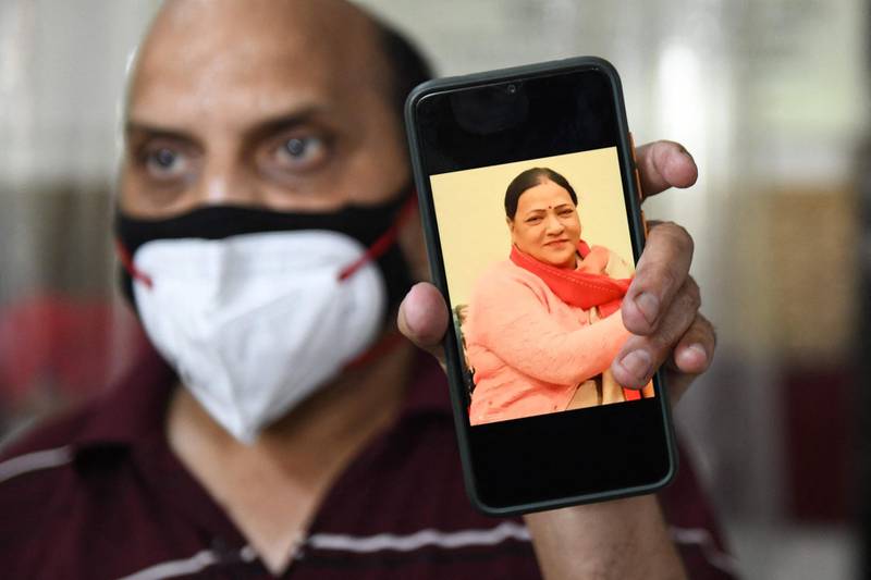 Jagdish Chand Sharma shows a photograph of his late wife Anita sharma, who was a Covid-19 patient at Dr Karam Singh Memorial Multi Specially hospital in Amritsar. AFP
