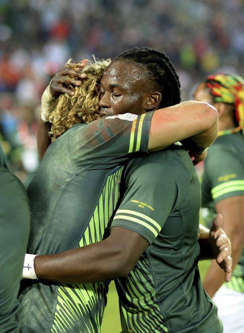South Africa’s Seabelo Senatla, right, hugs his teammate Werner Kok after winning the final. Martin Dokoupil / AP Photo