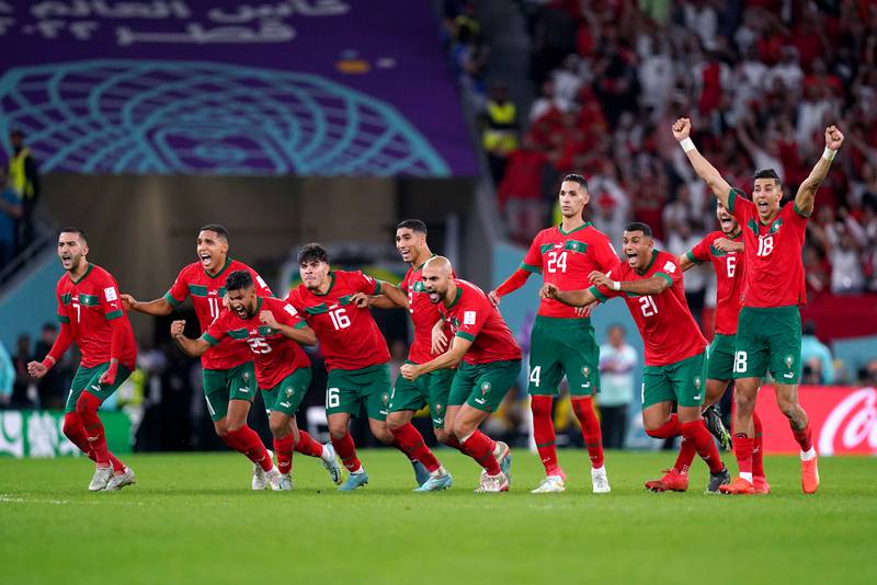 Morocco players react after goalkeeper Yassine Bounou saves a penalty from Spain's Carlos Soler. PA