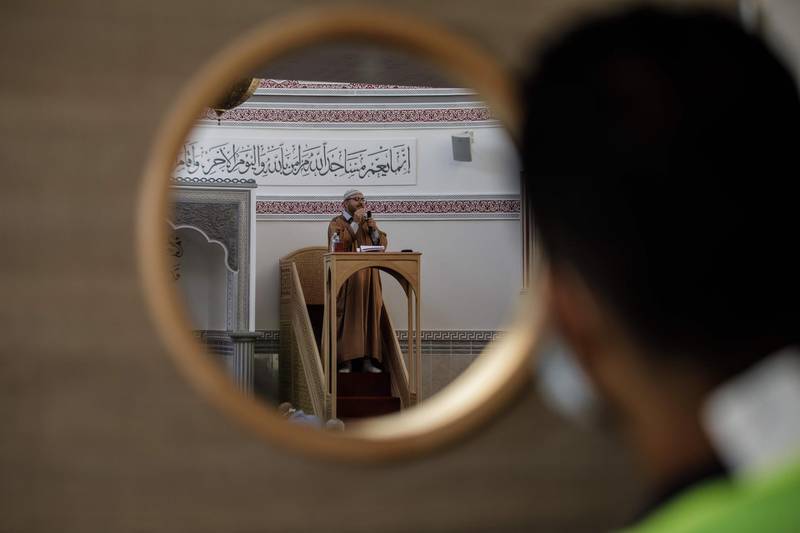 TOPSHOT - A cleric leads a prayer to celebrate Eid al-Adha at Maryam Mosque in the city of Caen northwestern France on July 31, 2020. Eid Al-Adha is celebrated each year by Muslims sacrificing various animals according to religious traditions, including cows, camels, goats and sheep. The festival marks the end of the Hajj pilgrimage to Mecca and commemorates Prophet Abraham's readiness to sacrifice his son to show obedience to God. Mosques started to reopen as France eases lockdown measures after the spreading of the COVID-19 (novel coronavirus) while respecting barrier gestures. / AFP / Sameer Al-DOUMY

