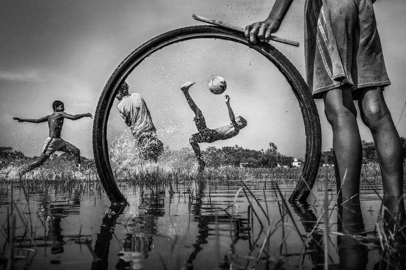 Third prize for the general category (black and white' is an action-packed image of children playing in India, shot by Sujan Sarkar and titled 'The Young Dreamers'. Sujan Sarkar