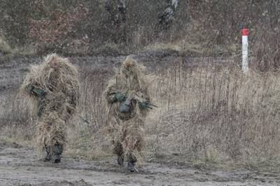 Camouflaged snipers on the move during the visit of German Minister of Defence Christine Lambrecht to the 9th Panzerlehr Brigade in Munster, northern Germany. EPA