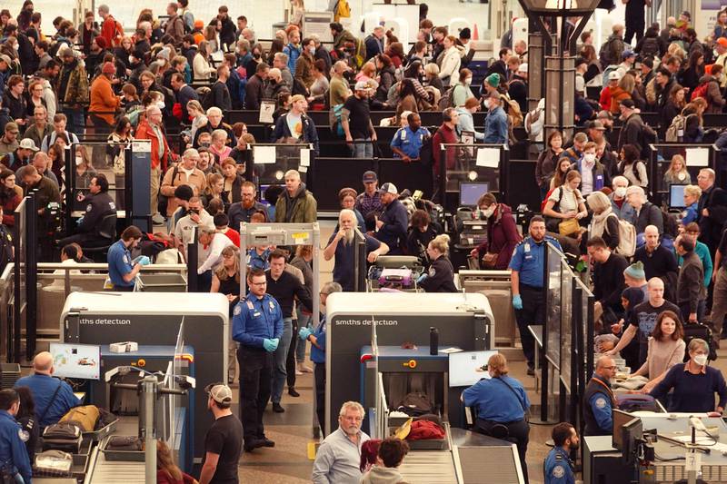 Travellers move slowly through security checkpoints at Denver International Airport. Getty
