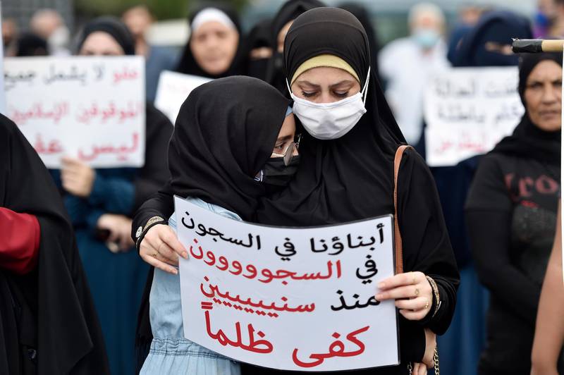 A girl hugs her mother during a protest for relatives and families of Islamic prisoners at Roumieh prison as they carry placards calling for clemency for their relatives in the coastal town of Sidon, Lebanon. EPA