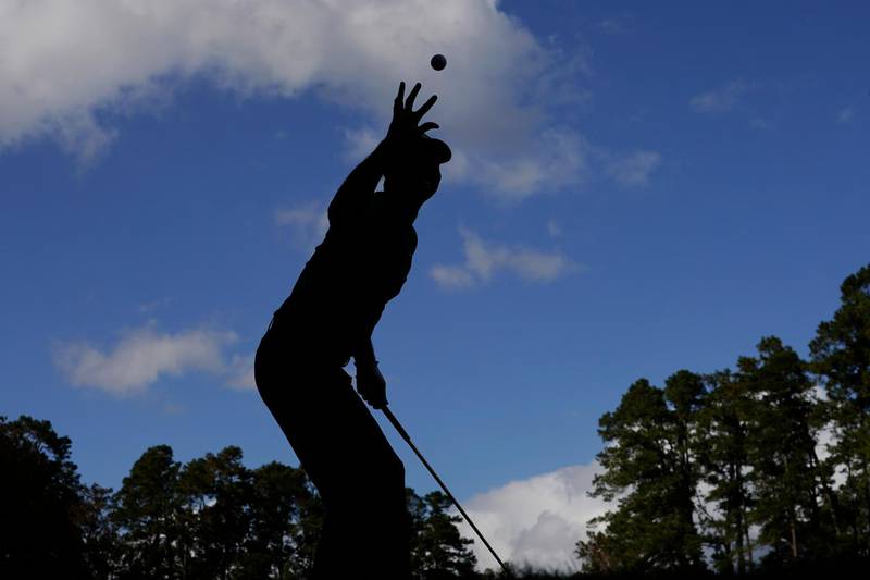Tiger Woods catches a ball from his caddie before teeing-off on the 16th hole during a practice round for the Masters golf tournament on Monday, November 9. AP