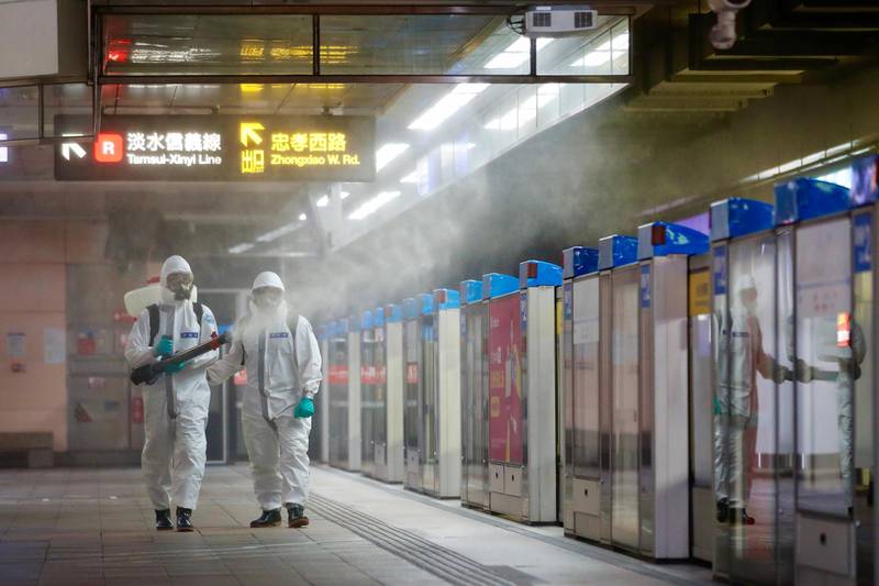 Military personnel spray disinfectant inside the Taipei Main Station in Taiwan. EPA