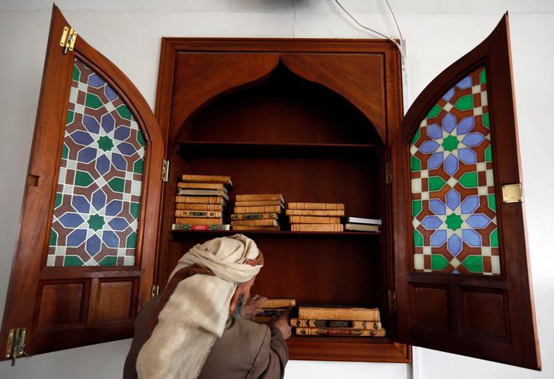 A Yemeni collects the copies of the Koran on the first day of the Muslim holy month of Ramadan at a mosque in Sana'a, Yemen, 24 April 2020. EPA