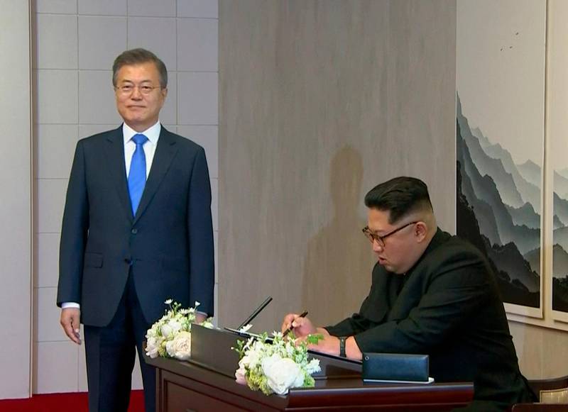 North Korean leader Kim Jong-un signs the guest book. Korea Broadcasting System via AP