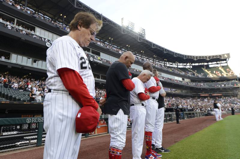 Chicago White Sox manager Tony La Russa, left, and his coaches bow their heads during a moment of silence at Guaranteed Rate Field. AP