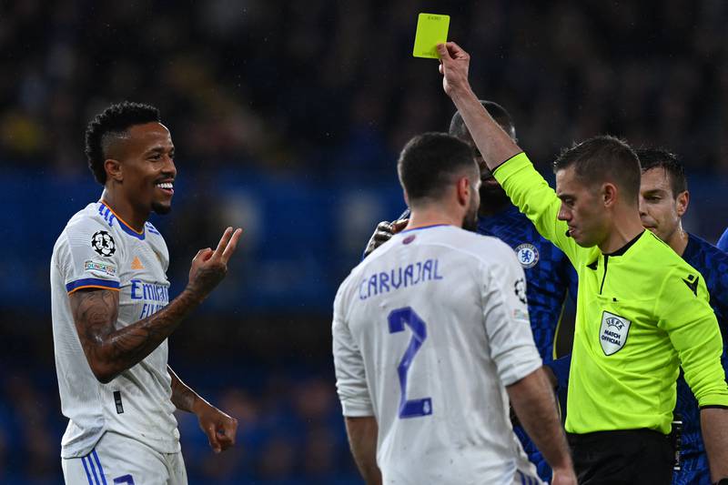 Real defender Eder Militao is booked by French referee Clement Turpin. AFP
