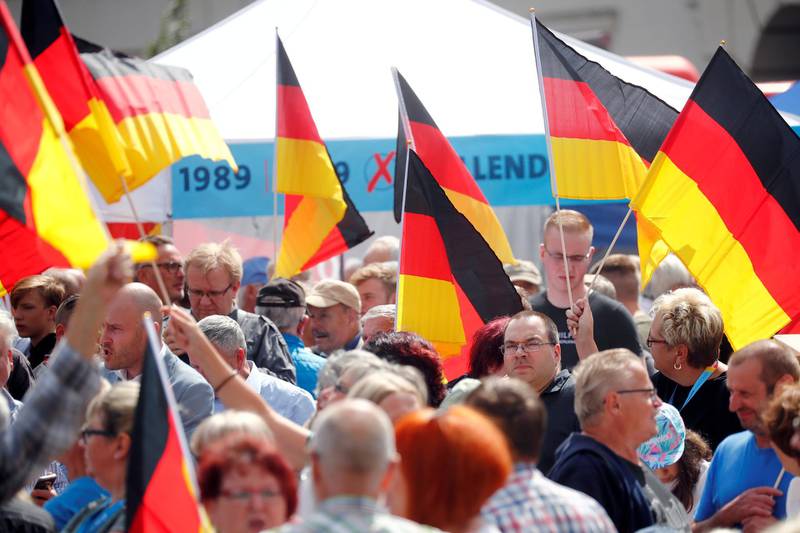 FILE PHOTO: People attend an election campaign event by Germany's far-right Alternative for Germany (AfD) party in Cottbus, Germany, July 13, 2019. REUTERS/Hannibal Hanschke/File Photo