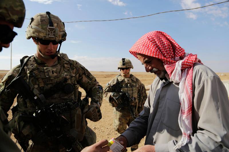 In this Jan. 27, 2018, photo, U.S. Army 1st Lt. Kyle Hagerty speaks to a shepherd in rural Anbar on on a reconnaissance patrol near a coalition outpost in western Iraq. A few hundred American troops are stationed at a small outpost near the town of Qaim along Iraq's border with Syria. Thousands of U.S. troops and billions of dollars spent by Washington helped bring down the Islamic State group in Iraq, but many of the divisions and problems that helped fuel the extremistsâ€™ rise remain. (AP Photo/Susannah George)