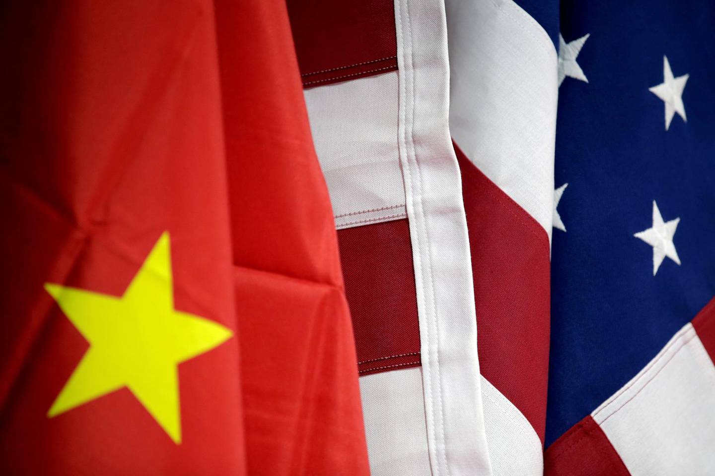 FILE PHOTO: Flags of U.S. and China are displayed at American International Chamber of Commerce (AICC)'s booth during China International Fair for Trade in Services in Beijing, China, May 28, 2019. REUTERS/Jason Lee/File Photo